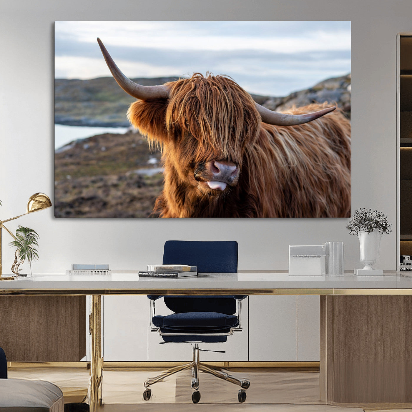 71222-MGV-CV-36X24-A playful Highland cow with shaggy fur sticks out its tongue, set against a rugged landscape — perfect for quirky home or office