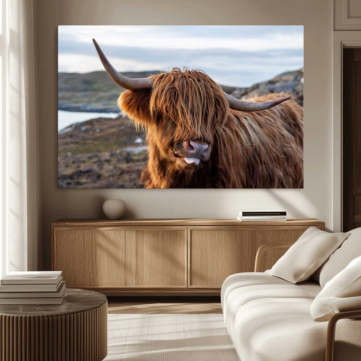 71222-MGV-CV-36X24-A playful Highland cow with shaggy fur sticks out its tongue, set against a rugged landscape — perfect for quirky home or office
