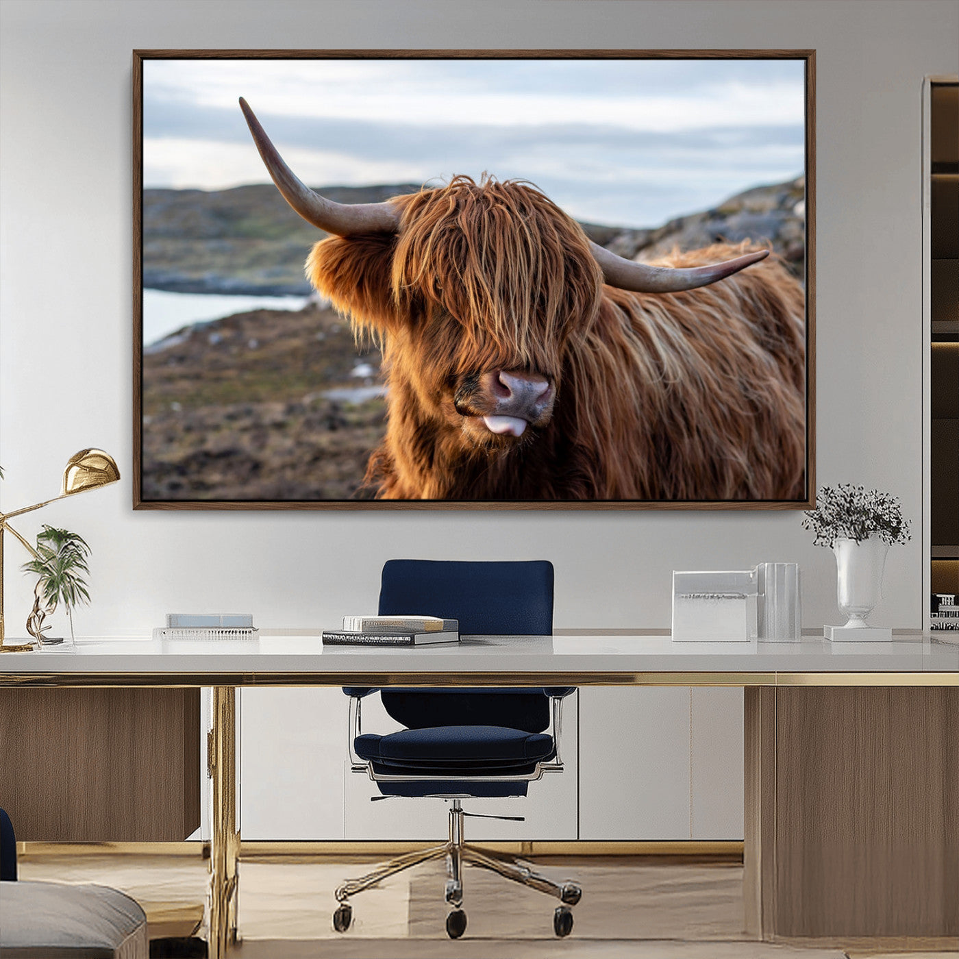 71222-MGV-CV-36X24-A playful Highland cow with shaggy fur sticks out its tongue, set against a rugged landscape — perfect for quirky home or office
