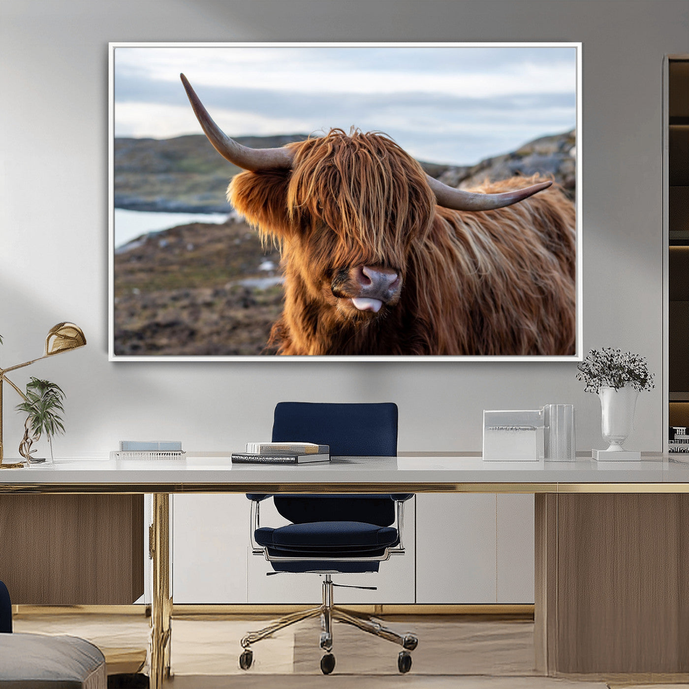 71222-MGV-CV-36X24-A playful Highland cow with shaggy fur sticks out its tongue, set against a rugged landscape — perfect for quirky home or office