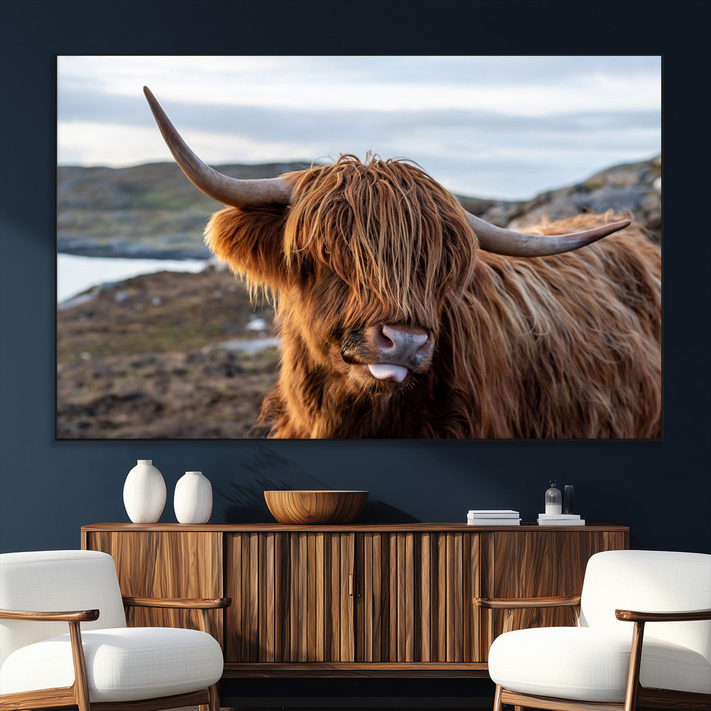 71222-SEG-FC-51X34_Oversize_Oversize-A playful Highland cow with shaggy fur sticks out its tongue, set against a rugged landscape — perfect for quirky home or office