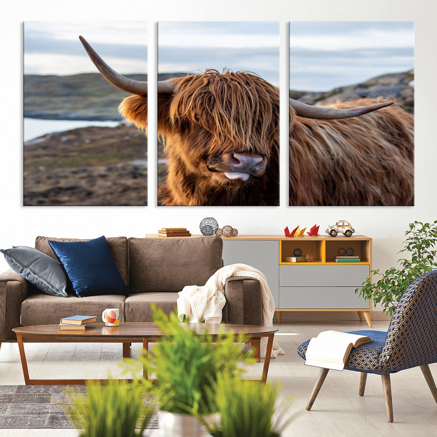 71222-MGV-CV-36X24-A playful Highland cow with shaggy fur sticks out its tongue, set against a rugged landscape — perfect for quirky home or office
