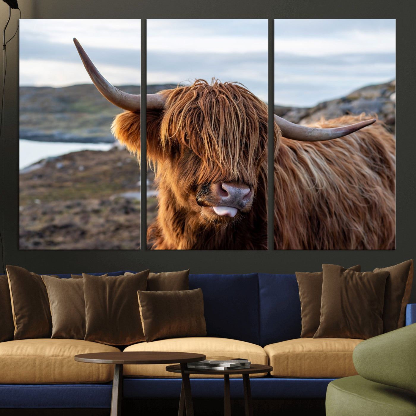 71222-MGV-CV-36X24-A playful Highland cow with shaggy fur sticks out its tongue, set against a rugged landscape — perfect for quirky home or office