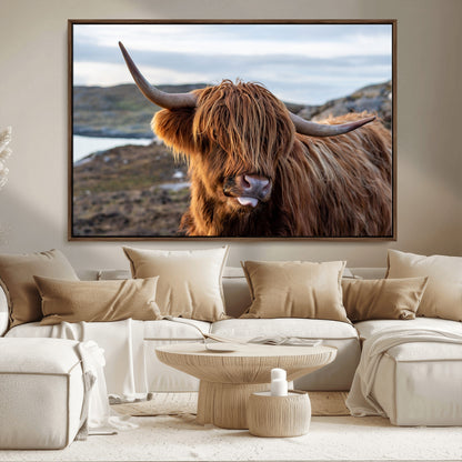 71222-MGV-CV-36X24-A playful Highland cow with shaggy fur sticks out its tongue, set against a rugged landscape — perfect for quirky home or office