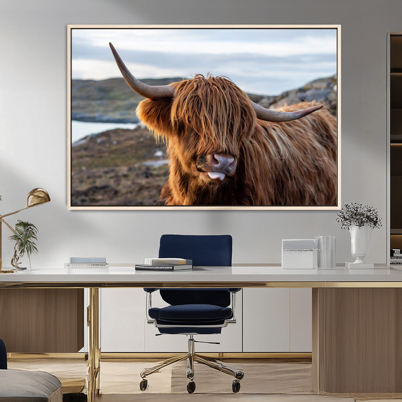 71222-MGV-CV-36X24-A playful Highland cow with shaggy fur sticks out its tongue, set against a rugged landscape — perfect for quirky home or office