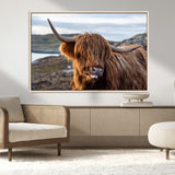 71222-MGV-FC-36X24_Natural-A playful Highland cow with shaggy fur sticks out its tongue, set against a rugged landscape — perfect for quirky home or office