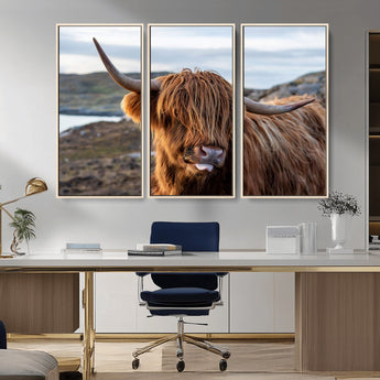 71222-MGV-FC-48X32-3P_Natural-A playful Highland cow with shaggy fur sticks out its tongue, set against a rugged landscape — perfect for quirky home or office