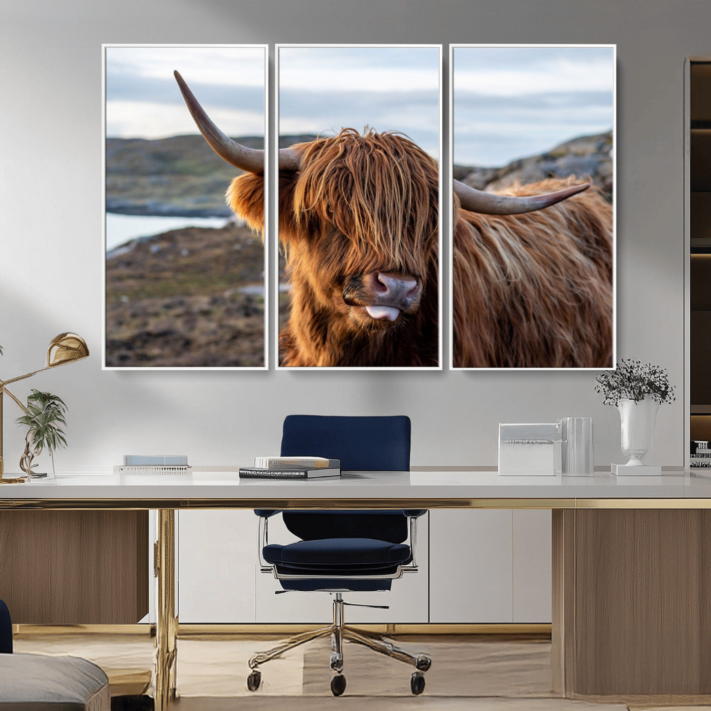 71222-MGV-FC-48X32-3P_White-A playful Highland cow with shaggy fur sticks out its tongue, set against a rugged landscape — perfect for quirky home or office