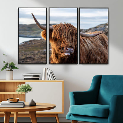 71222-MGV-CV-36X24-A playful Highland cow with shaggy fur sticks out its tongue, set against a rugged landscape — perfect for quirky home or office