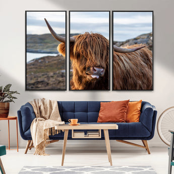 71222-MGV-CV-36X24-A playful Highland cow with shaggy fur sticks out its tongue, set against a rugged landscape — perfect for quirky home or office