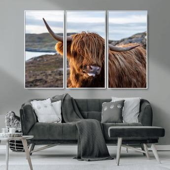 71222-MGV-CV-36X24-A playful Highland cow with shaggy fur sticks out its tongue, set against a rugged landscape — perfect for quirky home or office