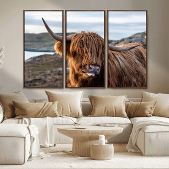 71222-MGV-CV-36X24-A playful Highland cow with shaggy fur sticks out its tongue, set against a rugged landscape — perfect for quirky home or office