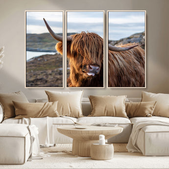 71222-MGV-CV-36X24-A playful Highland cow with shaggy fur sticks out its tongue, set against a rugged landscape — perfect for quirky home or office