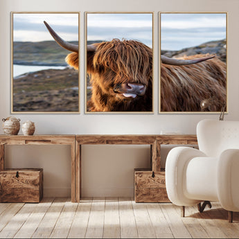 71222-MGV-FC-60X30-3P_Natural-A playful Highland cow with shaggy fur sticks out its tongue, set against a rugged landscape — perfect for quirky home or office