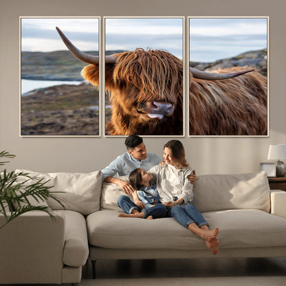 71222-MGV-CV-36X24-A playful Highland cow with shaggy fur sticks out its tongue, set against a rugged landscape — perfect for quirky home or office