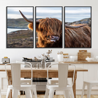 71222-MGV-FC-60X30-3P_Black-A playful Highland cow with shaggy fur sticks out its tongue, set against a rugged landscape — perfect for quirky home or office