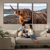 71222-MGV-CV-36X24-A playful Highland cow with shaggy fur sticks out its tongue, set against a rugged landscape — perfect for quirky home or office