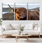 71222-MGV-CV-36X24-A playful Highland cow with shaggy fur sticks out its tongue, set against a rugged landscape — perfect for quirky home or office