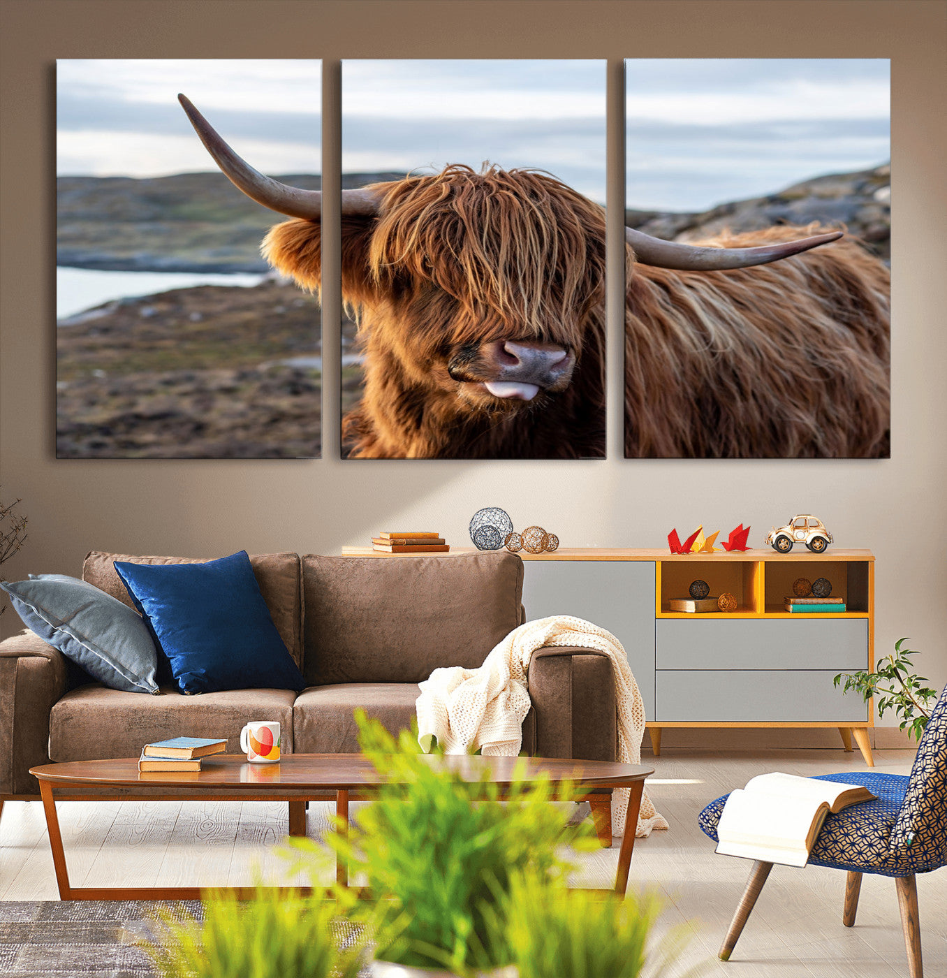71222-MGV-CV-36X24-A playful Highland cow with shaggy fur sticks out its tongue, set against a rugged landscape — perfect for quirky home or office